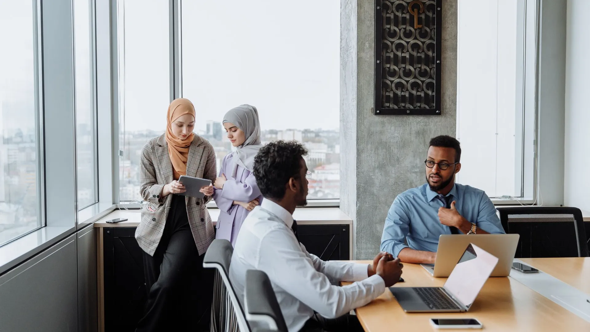 A diverse group of professionals engaged in a collaborative meeting in a modern office space.