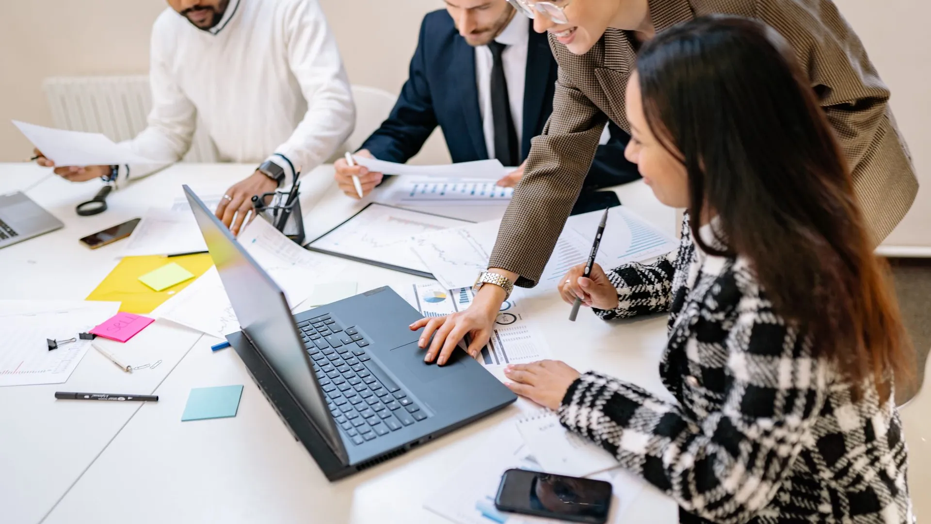 Diverse team working together on a project in a modern office environment.