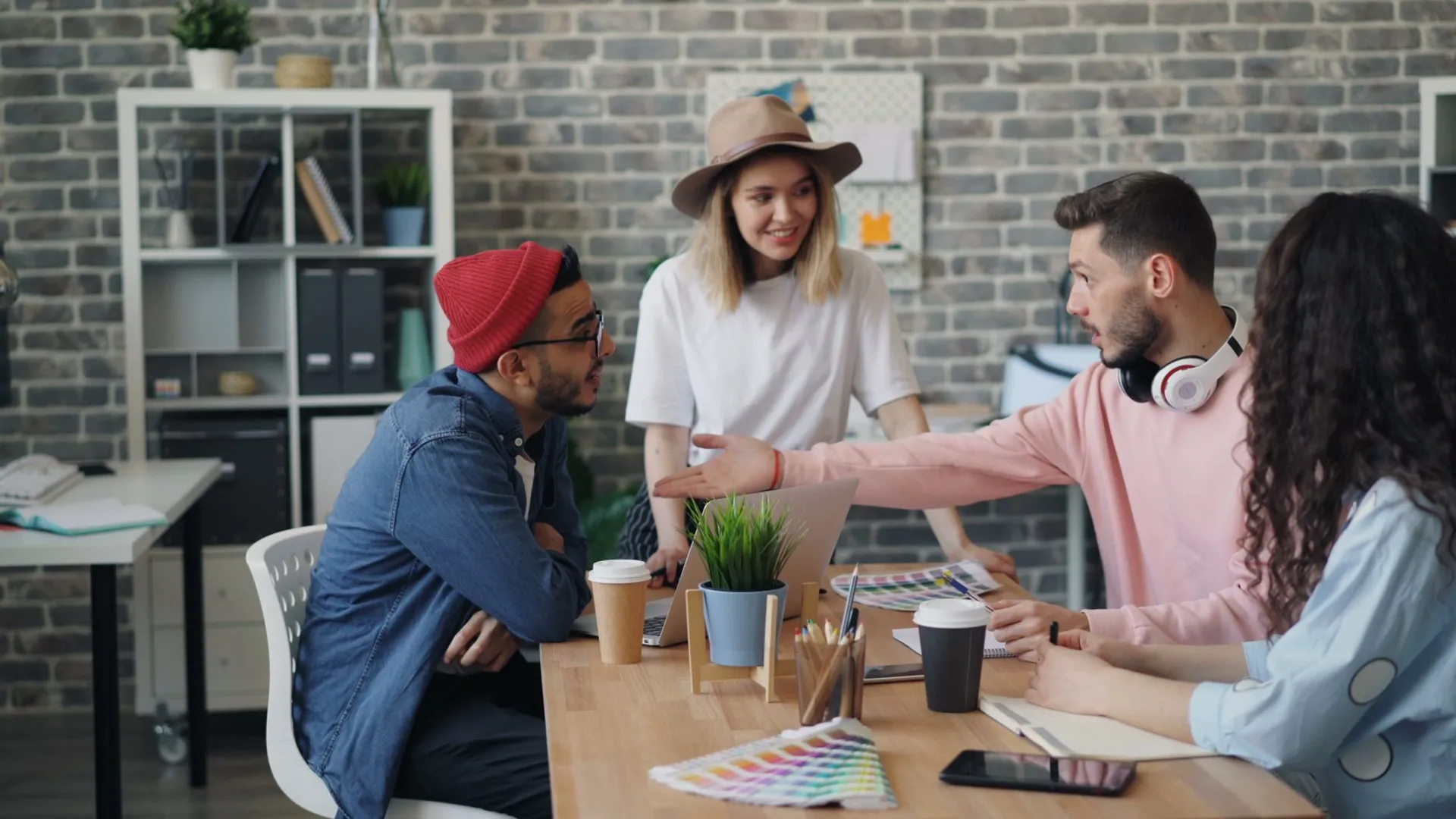Group of young professionals brainstorming ideas in a modern office environment.